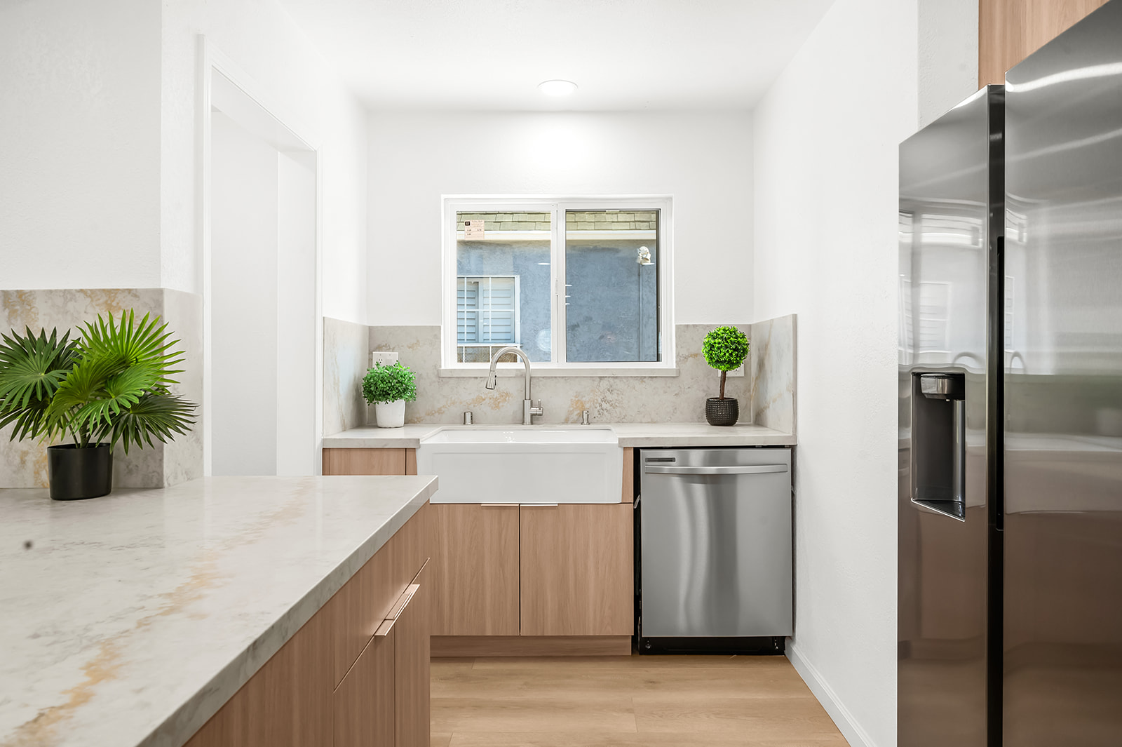 Butler's pantry with farmhouse sink and quartz counters
