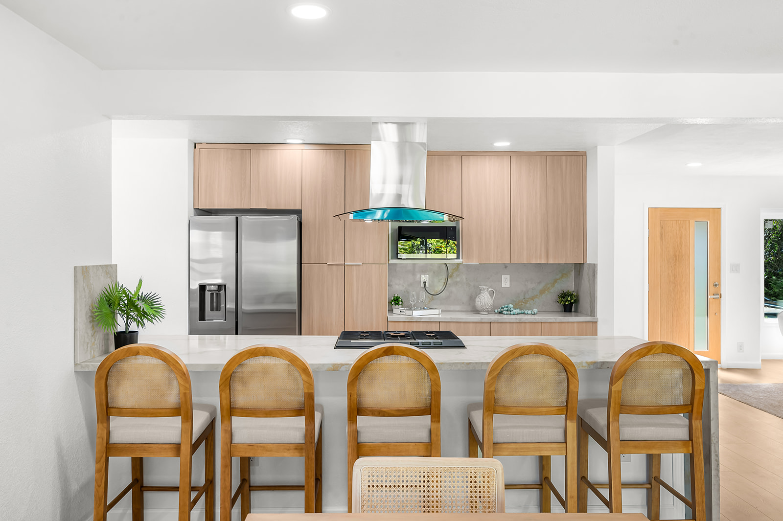 Kitchen island seating five with marbled quartz waterfall